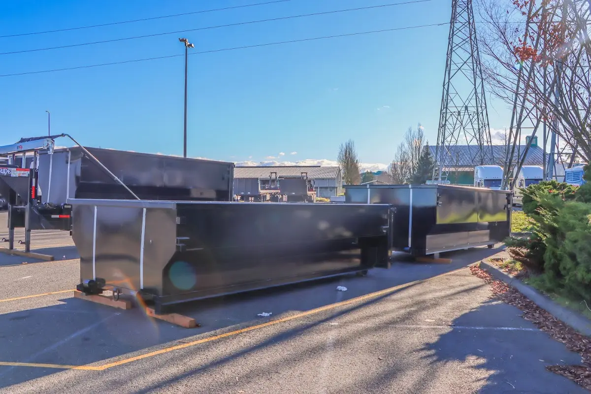 Roll-off dumpster ready for waste disposal at job site for 2 Yard Dumpster Rental in Oak Harbor